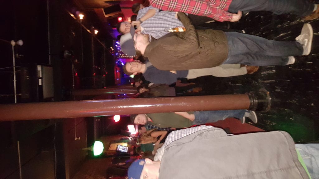 A crowd of people standing around in a room.